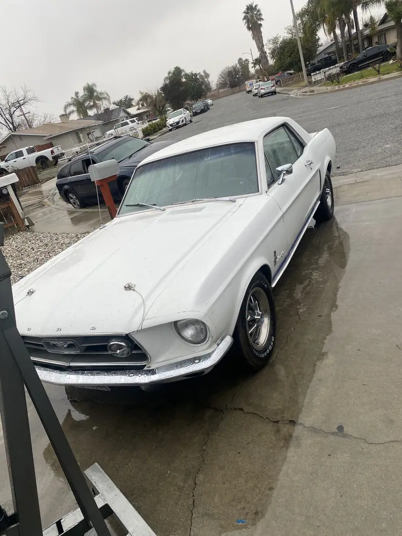 White 1967 Ford Mustang parked in the Supercanic driveway, February 2025