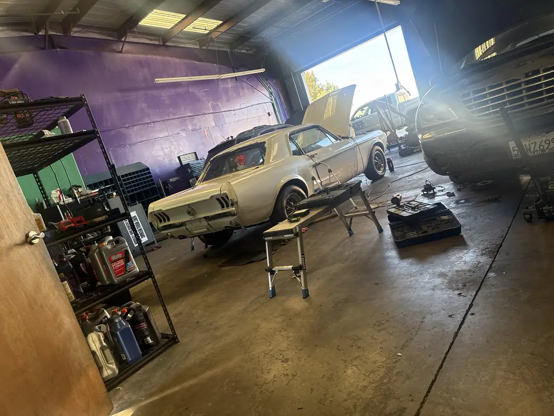 1967 Mustang inside the Supercanic shop bays with the purple wall